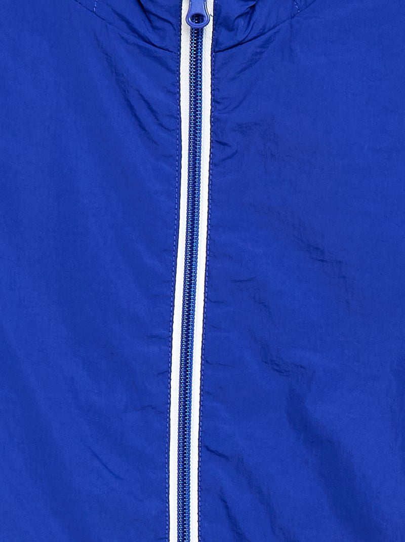 Coupe-vent uni qui se range dans sa capuche Bleu - Kiabi