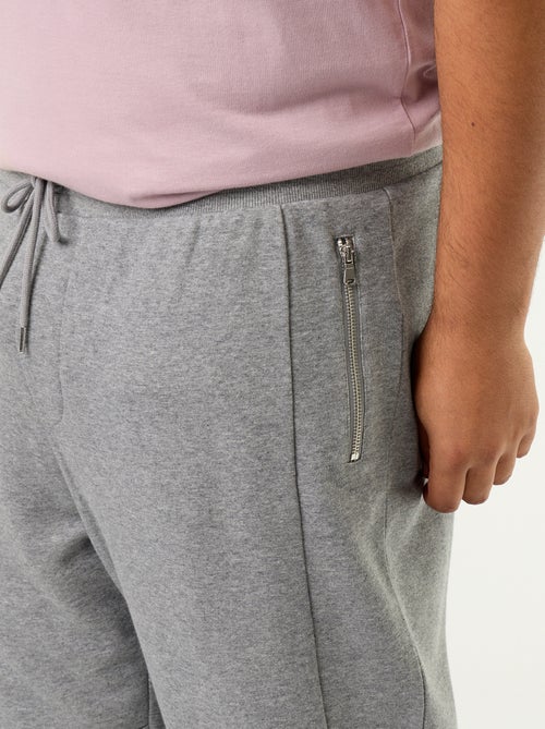 Pantaloni da jogging con fondo stretto e tasche con zip - Kiabi