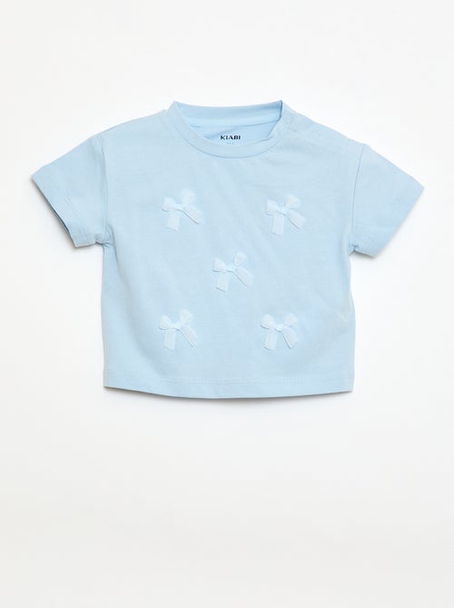 T-shirt in jersey a maniche corte con fiocchi decorativi - Kiabi T-shirt in jersey a maniche corte con fiocchi decorativi - Kiabi